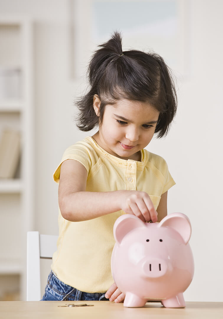 A little girl saving money